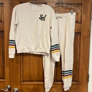 Sol Angeles medium size sweatshirt and sweatpants cream colored with navy logo